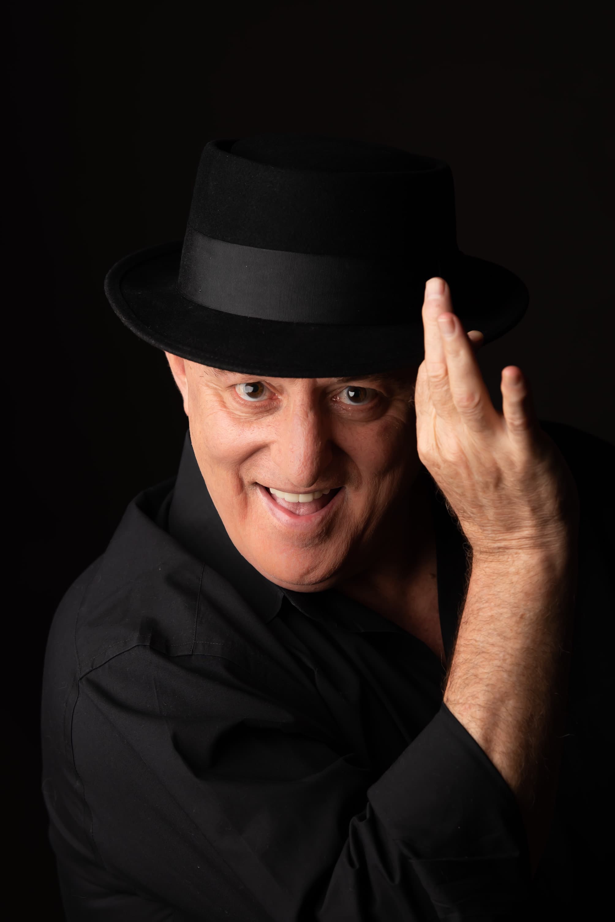 Scott Record in a black pork-pie hat, tipping the brim